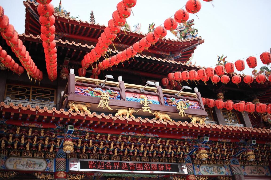 台中清水紫雲巖廟宇外觀,紅色燈籠高掛,彩繪屋簷與龍雕裝飾展現傳統宗教建築之美。